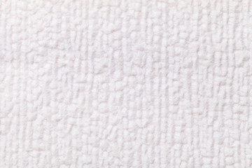 White fluffy background of soft, fleecy cloth. Texture of textile closeup.