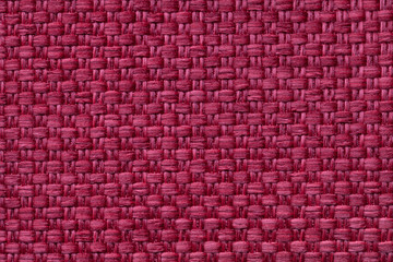 Dark red textile background with checkered pattern, closeup. Structure of the fabric macro.