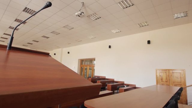 Empty lecture auditorium in the University. Close up view of the rostrum with the microphone.