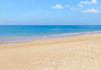 Fototapeta na wymiar Empty tropical beach and blue sea with blue sky and white cloud background 