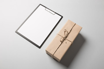 lipboard with blank paper and package.