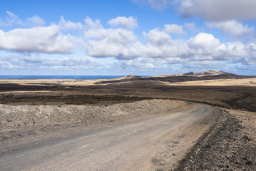 Fototapeta na wymiar Remote dirt road on the Atlantic island Fuerteventura.