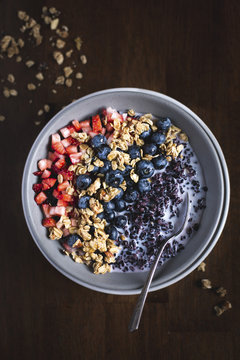 Bowl of black rice cereal with berries and granola