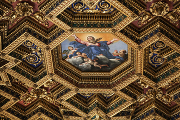  interiors and architectural details of basilica di Santa Maria in Trastevere in Rome, Italy. Octagonal ceiling painting Assumption of the Virgin by Domenichino