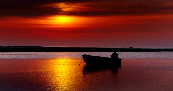 Silhouette of boat in sea during sunset