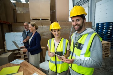 Warehouse workers standing together in warehouse