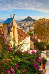 Fotobehang Lycabettus hill and a small Greek orthodox church in Anafiotika, Athens. © milangonda
