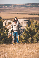 Beautiful loving couple in hipster fashion style posing on mountain