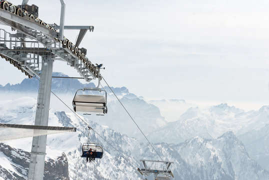 Ski lift chair with skier in mountain