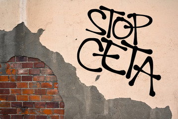 Stop CETA - handwritten graffiti sprayed on the wall - protest against international financial and...