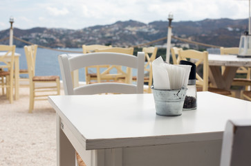 View of empty outdoor cafe in Crete, Greece. Selective focus on the table