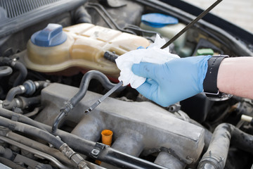 Fototapeta premium Mechanic checks the oil level in the engine