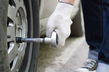 Young man changing wheel