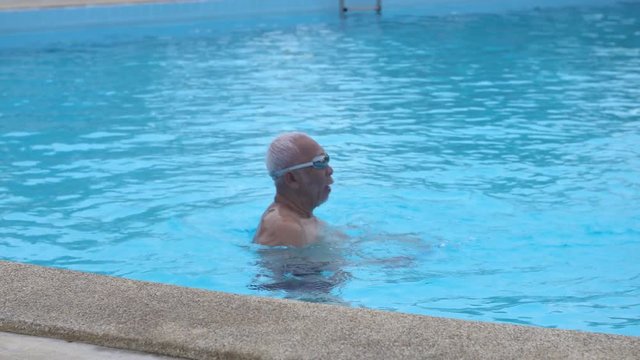 Happy asian old senior with grand sun playing in pool,Happy asian family play in swimming pool.