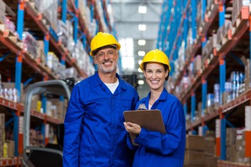 Warehouse workers standing together in warehouse