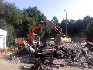 Fototapeta premium Stones, destroyed buildings, building. Demolition. A pile of stones. Crane