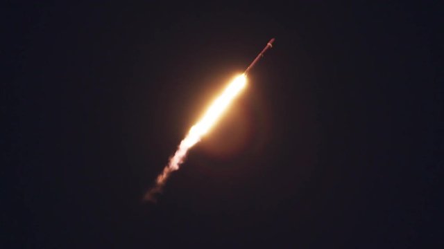 Rocket launch in sky at night