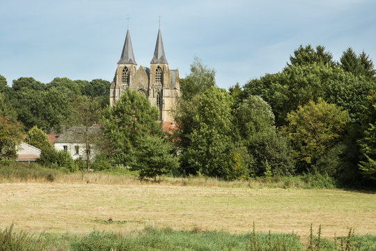 The field Basilica. Our Lady of Avioth seen from the fields, surrounded by a pastoral landscape