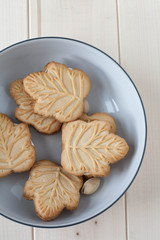 Maple leaf shaped cookies  in a white bowl
