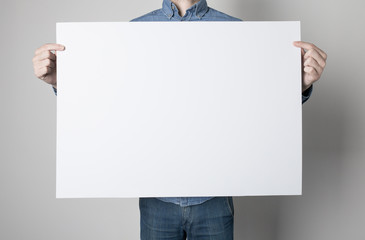 Man holding a white poster