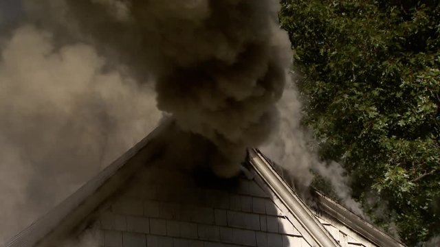 Zoom In Shot Of Smoke Coming Out From House