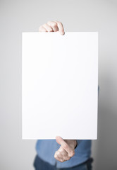 Man holding a white poster