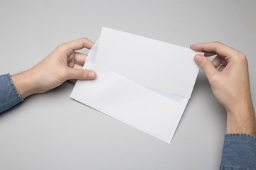 Hand holding Blank Envelope Mock-up