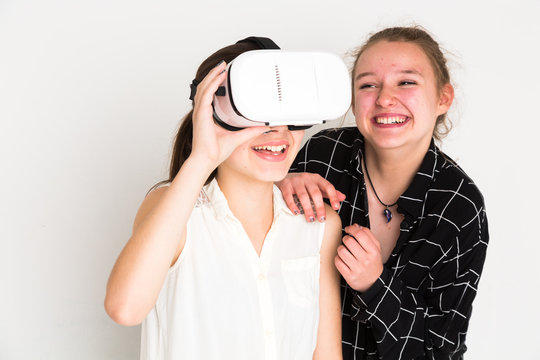 Amused teenage girls using virtual reality camera system
