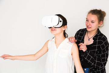 Young girls wearing a virtual reality camera