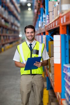Warehouse manager holding clipboard
