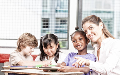Happy teacher with multi ethnic classroom at school