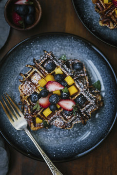 Plate of waffles with fresh fruits