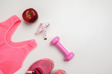 Sport lifestyle concept. Top view of dumbbells, sneakers and sport accessories on wooden desk.