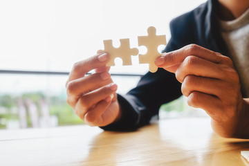 Business woman hands connecting jigsaw puzzle. Business solutions, success and strategy concept....