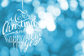 Merry Christmas and Happy New Year greetings card with azure, blue, turquoise blur light bokeh