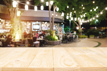 Empty wooden table space platform and blurred resturant background for product display montage..