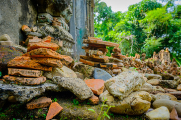 Fototapeta na wymiar A public ancient old vihara hall left in the forest for hundred years in Wat Somdej temple ,Sangkhaburi,Kanchaburi,Thailand. 