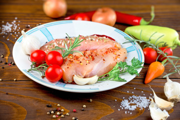 Raw chicken breast with spices (seasoning) ready to prepare meal