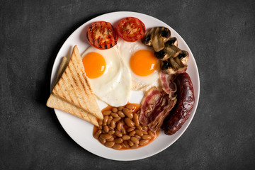 English breakfast on a black chalkboard, copy space