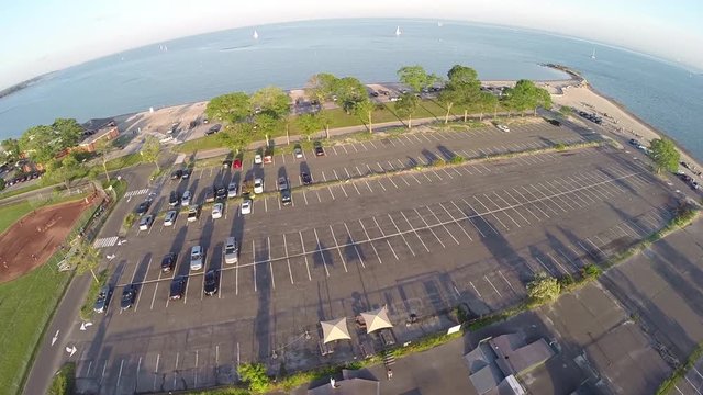 Aerial over parking lot by beach, Westport, Connecticut at Compo Beach.