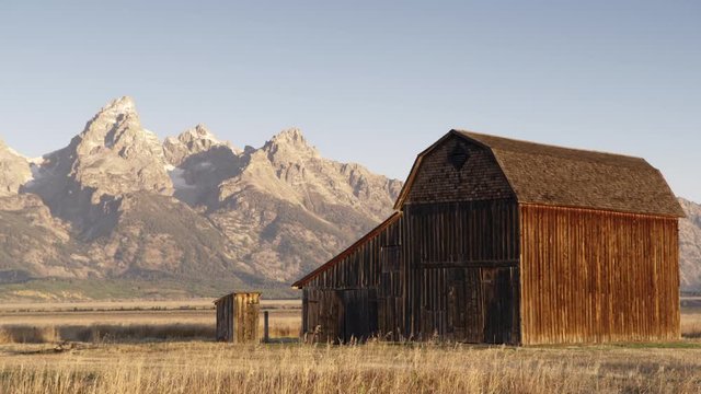 Wide shot of Moulton barn at Mormon Row, Rocky Mountains in background