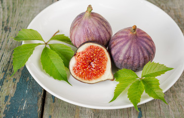 Ripe figs on a white plate