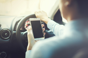 man using phone while driving the car (selective focus) - transportation and vehicle concept -...