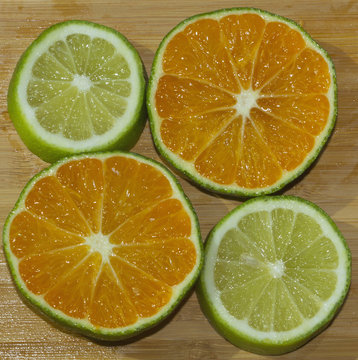 Slices of mandarin and lime on the cutting board
