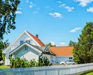 Cozy house with beautiful landscaping on a sunny day