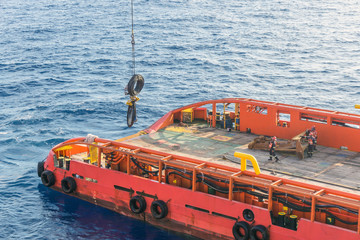 Anchor handling tug performing operation early in the morning at oilfield Malaysia