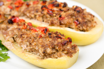 Stuffed zucchini with a mixture of vegetables with cheese and herbs. Traditionally baked squash filled with minced meat, cooked rice, onions, spices, covered with red paprika and cheese.Closeup