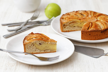 Piece of homemade apple pie on white table