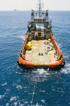 Offshore crew handling anchors on deck tugboat during anchor handling operations at Terengganu oilfield, Malaysia