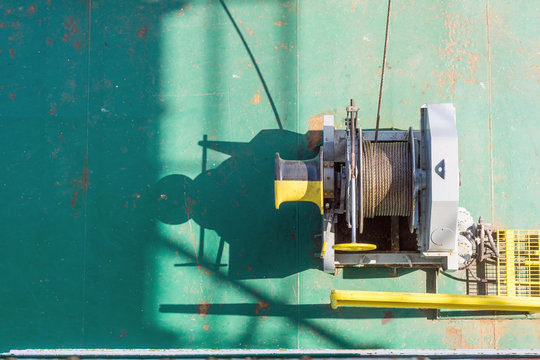 Air tugger winch on the bow of a construction barge